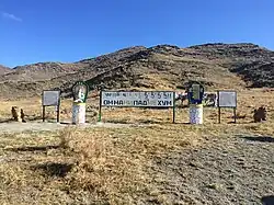 Тарина на перевале при въезде в кожуун. Мантра «Ом мани падме хум» на тибетском и кириллице