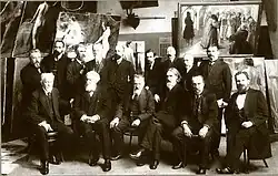 Фотография членов Совета Высшего художественного училища при ИАХ (1913 г.). Слево направо (сидят): В. Е. Маковский, М. П. Боткин, П. А. Брюллов, В. А. Беклемишев, В. Е. Савинский, И. И. Творожников. Стоят: Н. А. Бруни, В. В. Матэ, ?, Н. Н. Дубовской, Д. Н. Кардовский, ?, Н. С. Самокиш, Р. Р. Бах, В. И. Альбицкий (?)