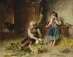 Дети играют с кроликами в конюшне