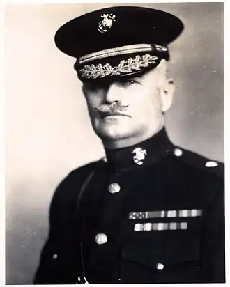 A black and white image of John Myers, a white male in his Marine Corps dress blue uniform. He has a moustache, is wearing a hat and several ribbons are visible.
