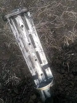 Отработанная кассета РС с кассетной БЧ «Урагана», 1 из секции углублена в почву