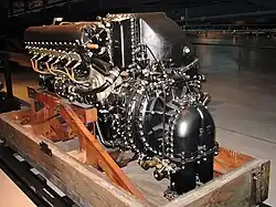 A rear view of an aircraft piston engine shows details of the induction system. The engine is sitting on a bespoke wooden pallet.