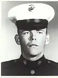 A black and white headshot image of Phipps wearing his military dress uniform with hat.