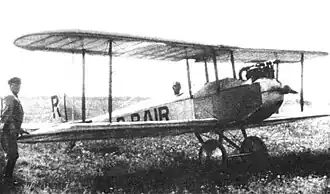 Ю. И. Пионтковский в кабине самолета АИР-1, у крыла — механик А. А. Демешкевич.