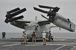 Запаркованный на палубе вертолетоносца №181 Хюга конвертоплан СкопаV-22 262-й эскадрильи КМП США(2013 г.)